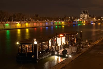 Houseboat with Louvre in the background and Olympic lighting